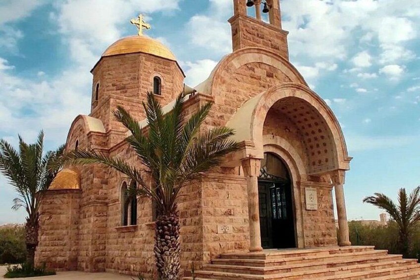 A church with a golden dome and a bell tower. 5