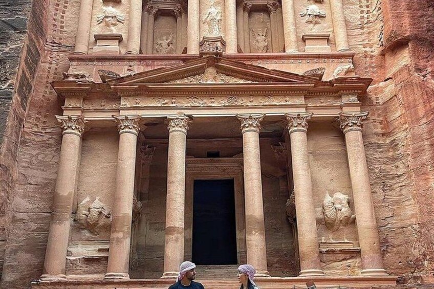 A large, ancient building with columns and detailed carvings. 1