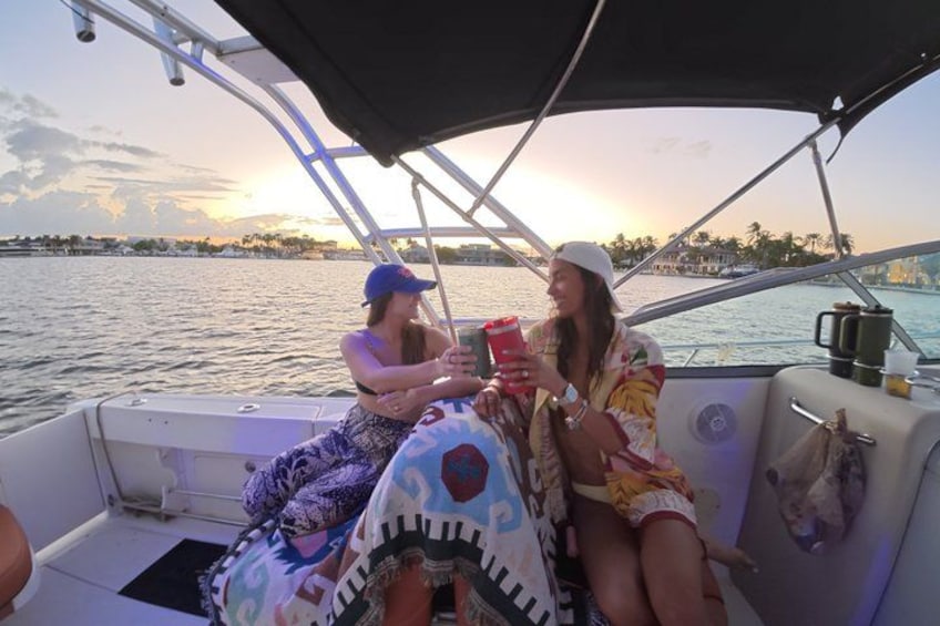 Two people on a boat with a sunset in the background. 2