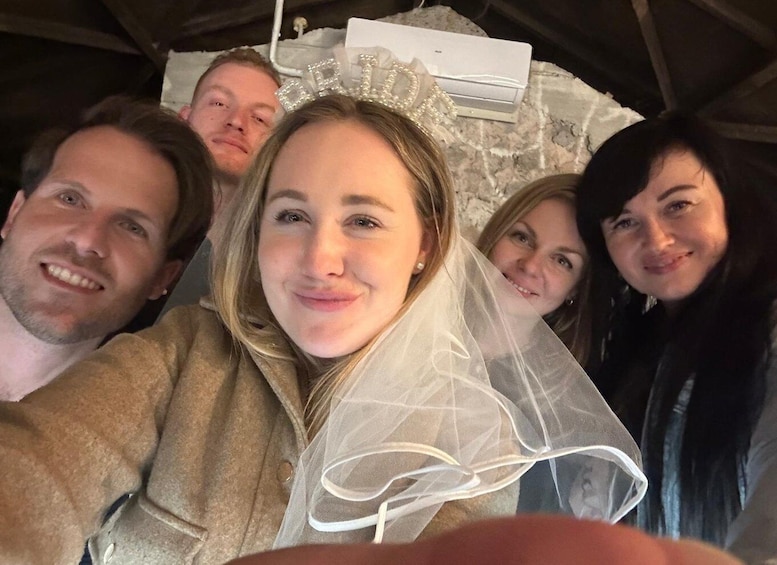 A group of people in a tent with a wedding dress and a tiara. 4
