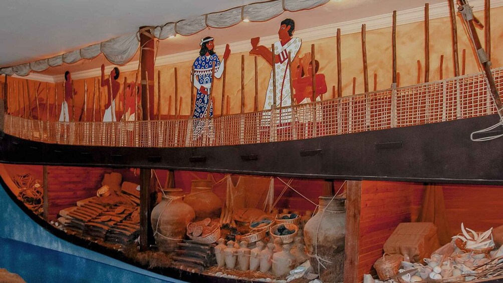 A model ship with figures dressed in traditional attire, a wooden deck, and various ship's equipment. 3