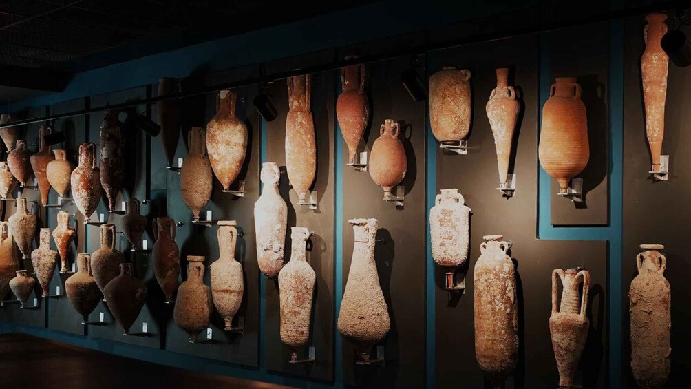 A collection of ancient pottery displayed on a wall. 2