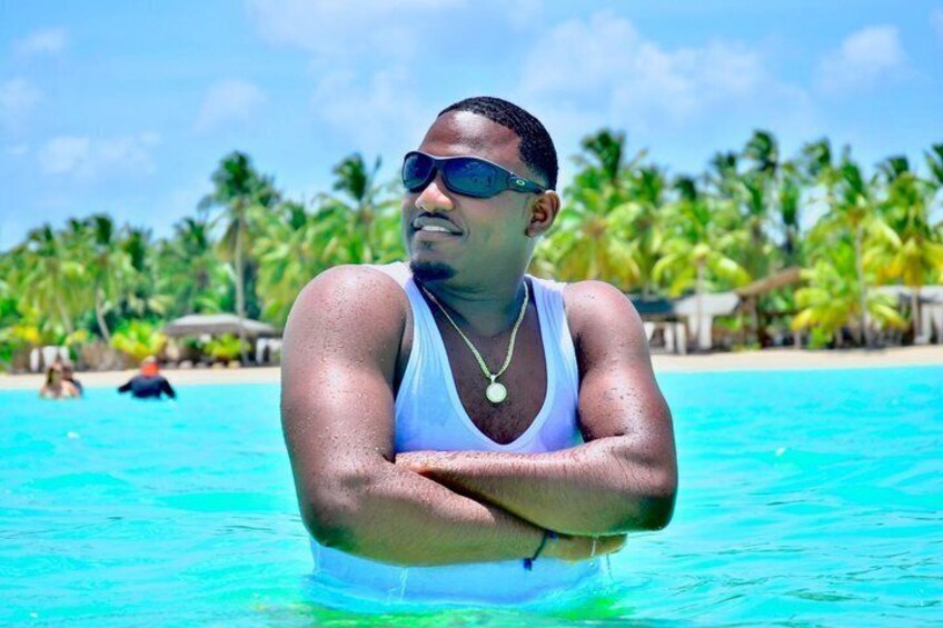 A person in a swimming pool with a tropical beach and palm trees in the background. 3