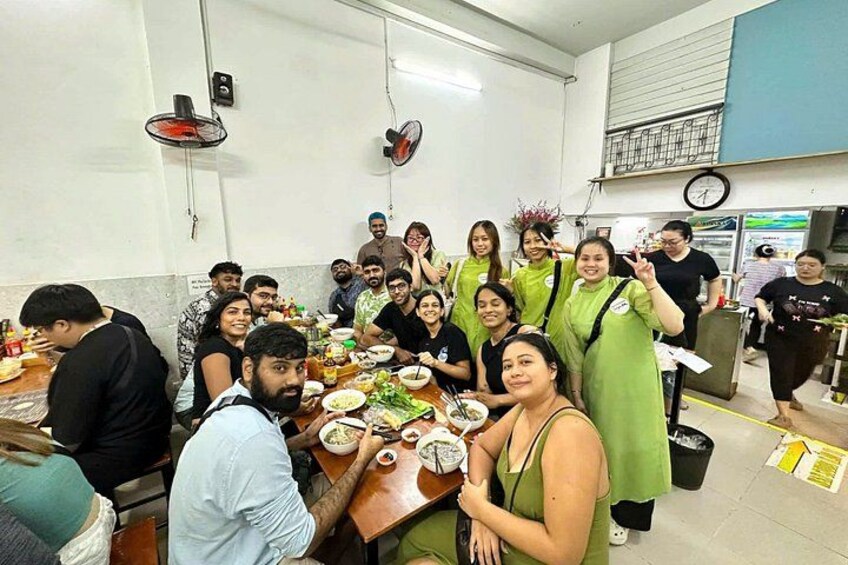 Un grupo de personas cenando en un restaurante con mesas y sillas. 2