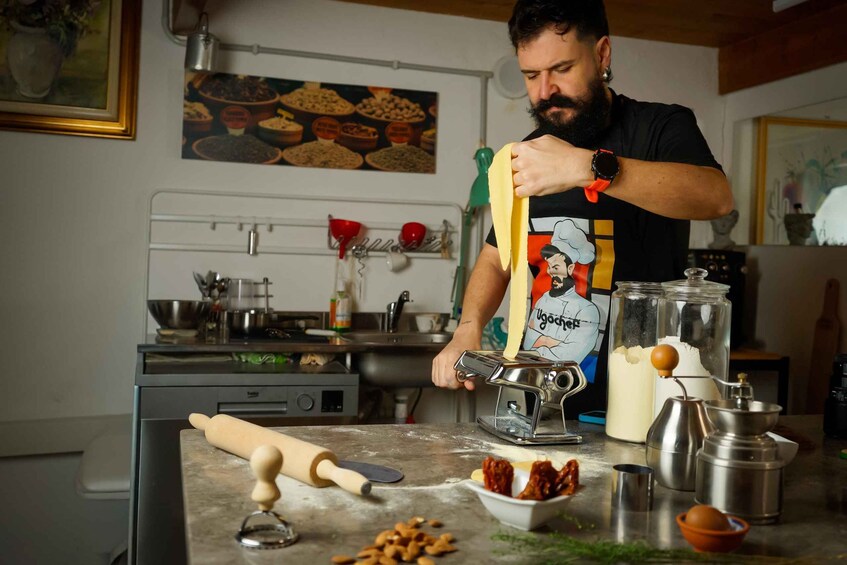 A person rolling dough on a kitchen counter with various baking tools and ingredients. 2