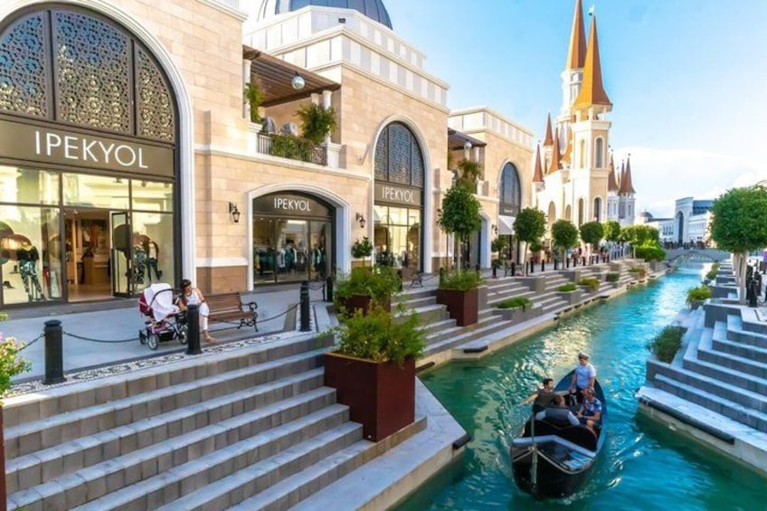 A canal with boats, a shopping area with IPEKYOL stores, and a castle-like building. 3