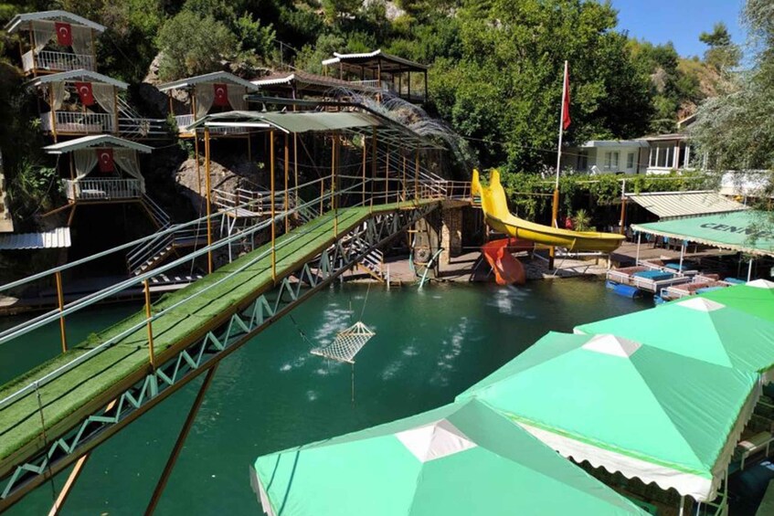 A water park with a bridge, boats, and buildings. 3