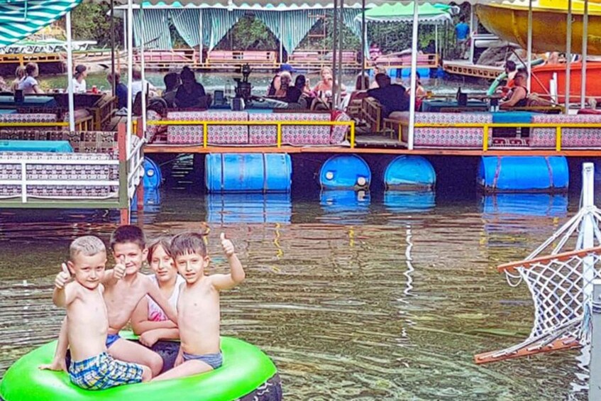 A water park with inflatable rafts, a basketball hoop, and people enjoying the facilities. 5