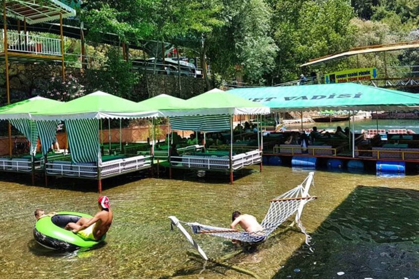 A water park with inflatable tubes, hammocks, and shaded areas. 4