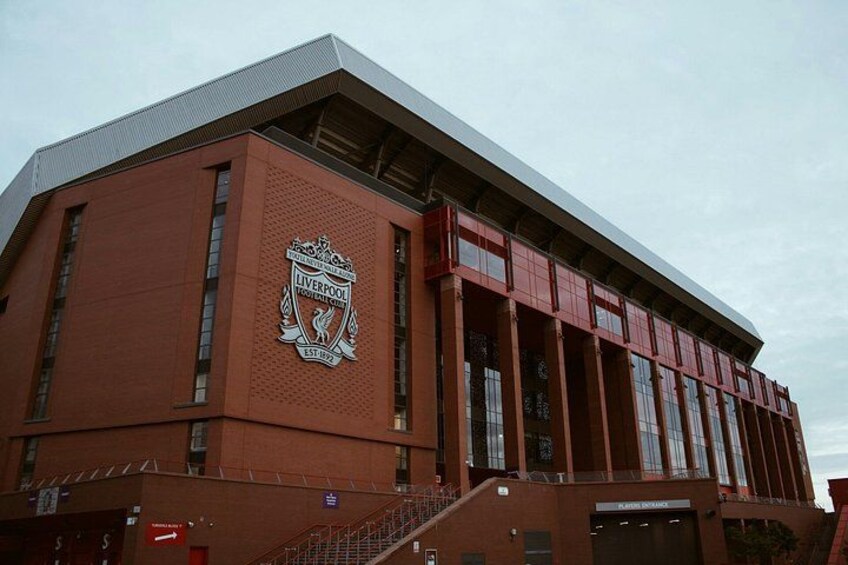 A red brick building with a large Liverpool FC logo. 4