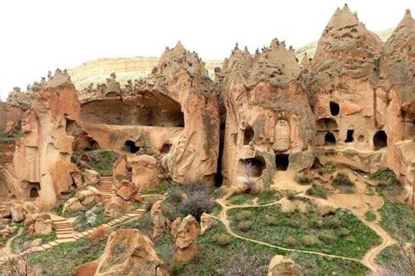 A rock formation with caves and a narrow path. 4