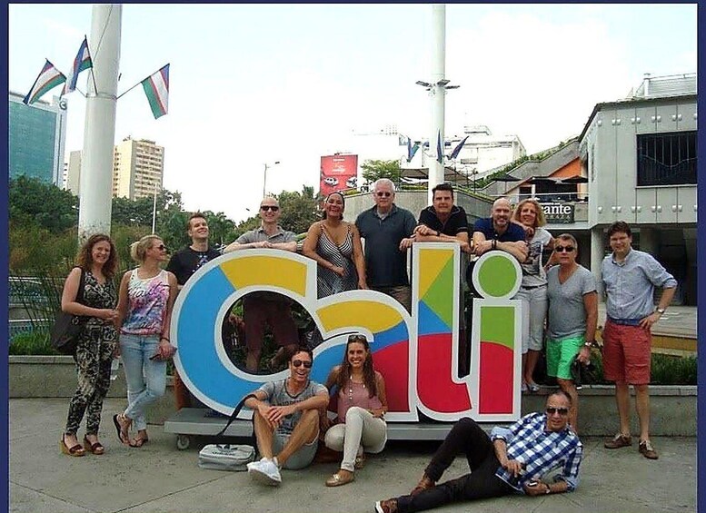A group of people posing with a colorful, oversized letter 'C' and 'i' sign. 3