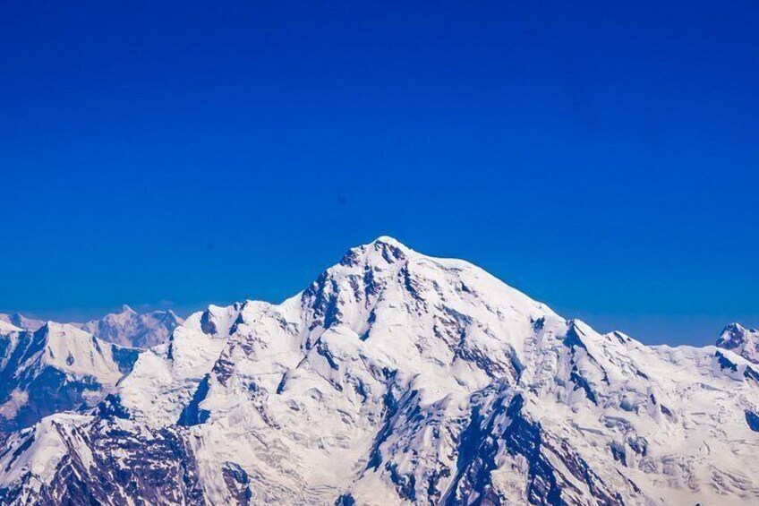 A snow-covered mountain range under a clear blue sky. 2