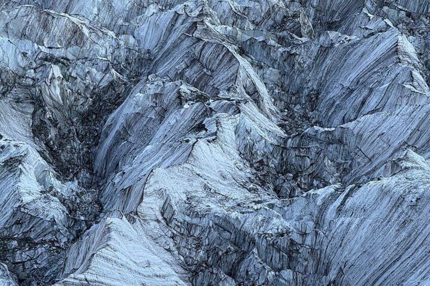 A close-up of a textured rock surface with layered formations. 3