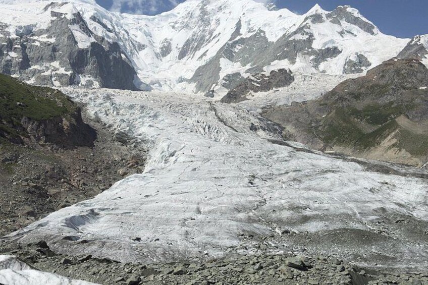 A glacier with a rugged mountain backdrop. 5