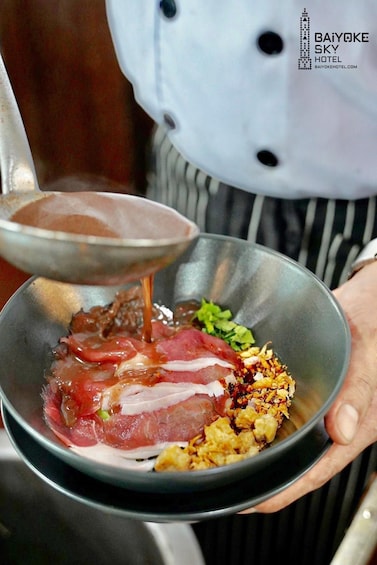 A chef preparing a dish with meat, vegetables, and sauce. 3