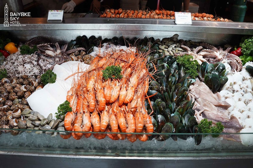 A seafood display with various types of shellfish and prawns. 4