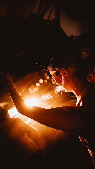 A person lying down with a glowing light source in front of them. 4