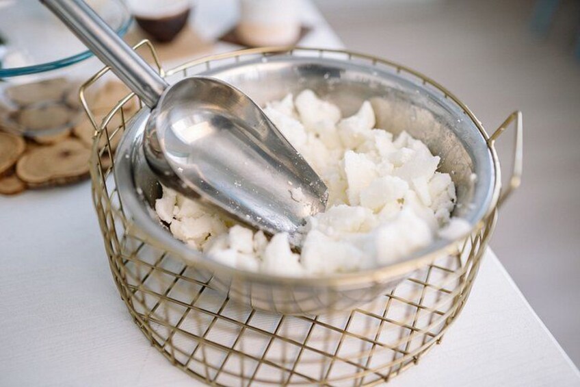 A colander with cubed cheese and a spoon. 4