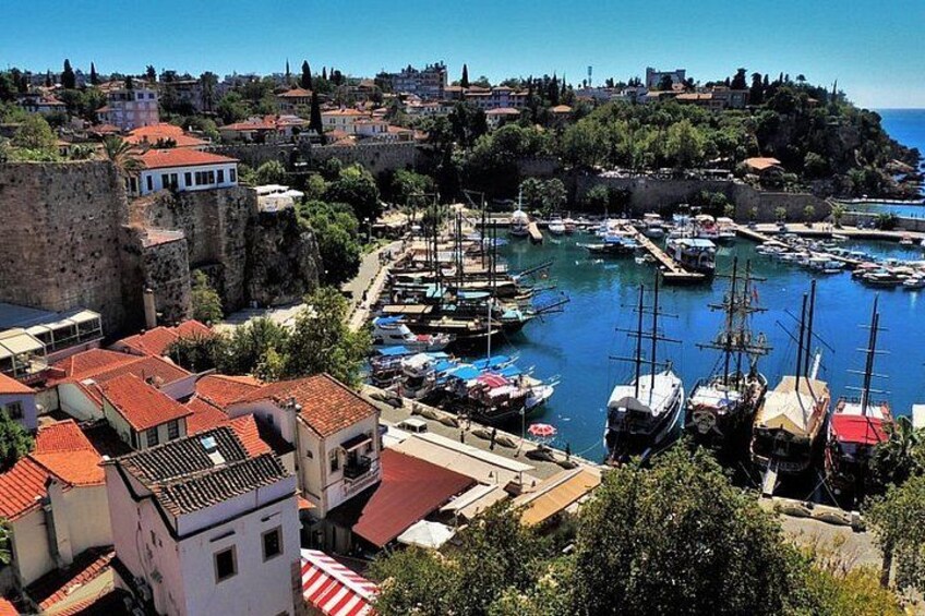 A coastal town with a historic harbor, stone walls, and traditional buildings. 2