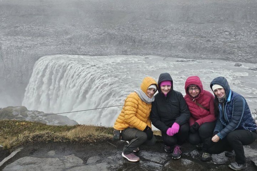 A group of people sitting by a waterfall. 5