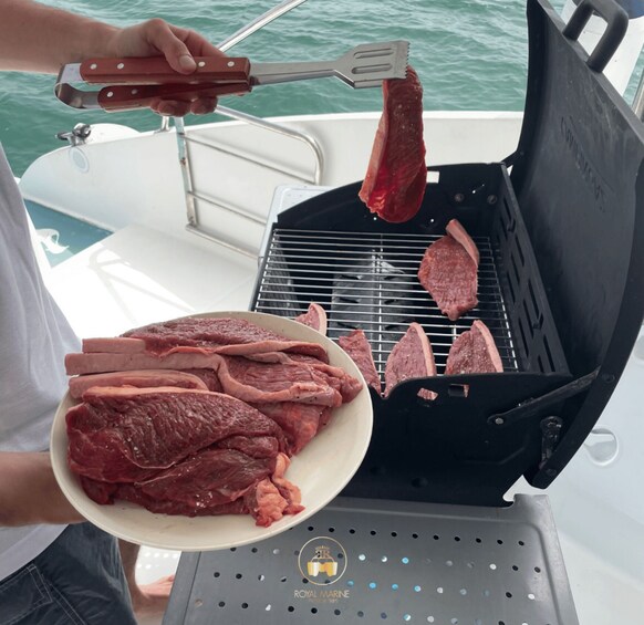 A person grilling steaks on a boat. 2