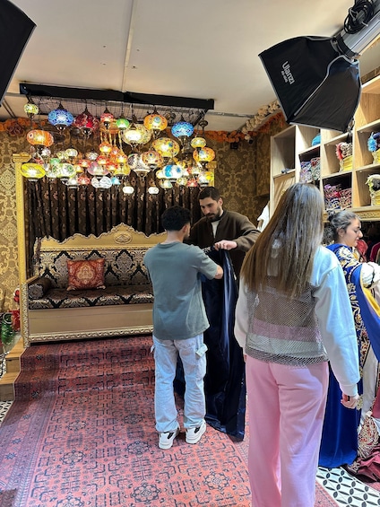 A room with ornate decorations, a patterned carpet, and a variety of colorful hanging lamps. 3