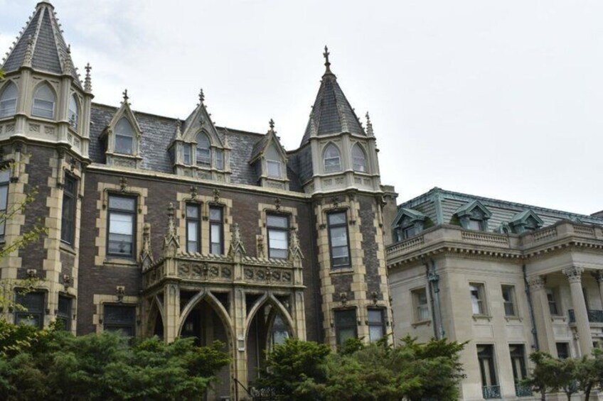 A large, historic building with Gothic architecture, including pointed towers and arched windows. 3
