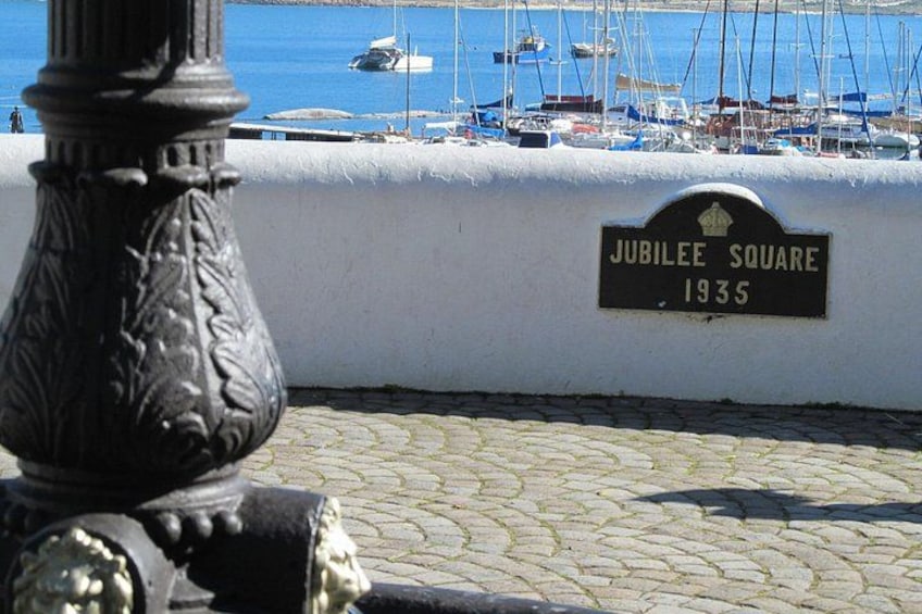 A cobblestone path, a black lamp post, and a sign reading 'Jubilee Square 1935.' 2