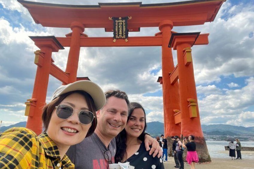 A red torii gate with a clear sky and mountains in the background. 1