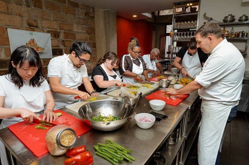 A group of chefs preparing food in a kitchen. 1