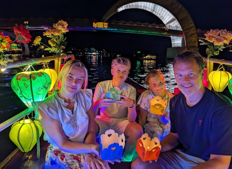 A group of people on a boat with decorative lanterns and flowers. 5