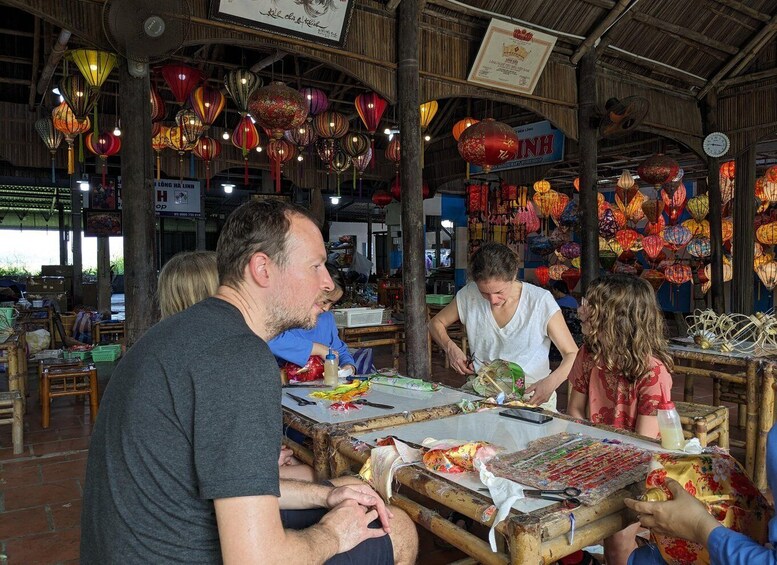A market stall with traditional lanterns and a sign for 'Binh Long.' 4
