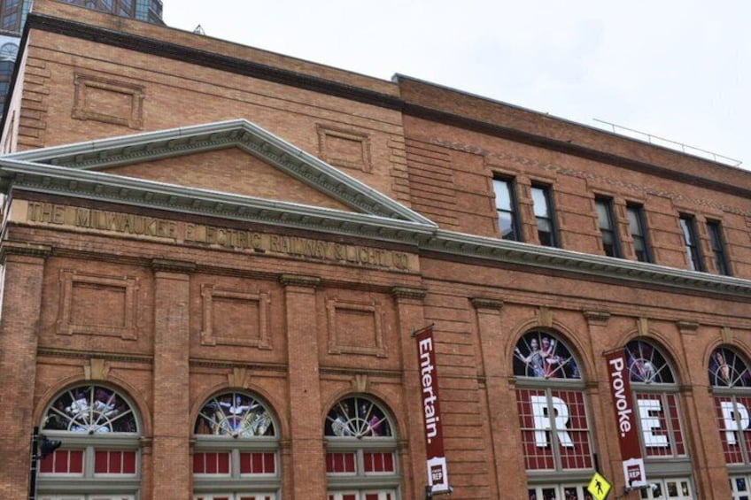 A brick building with arched windows and a sign that reads 'The Milwaukee Electric Railway Co.' 4