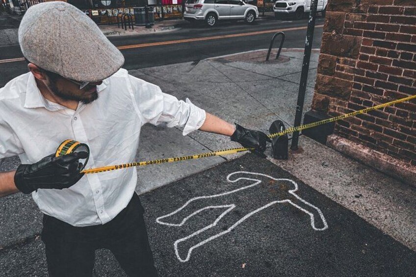 A person measuring a painted pedestrian crossing on the street. 3
