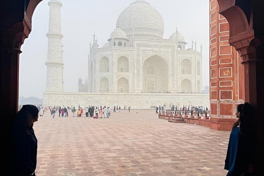 The Taj Mahal with a large crowd of people in the foreground. 2