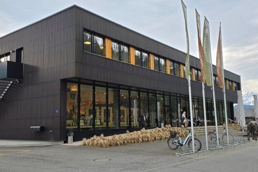 A modern building with large windows and a metal facade. 4