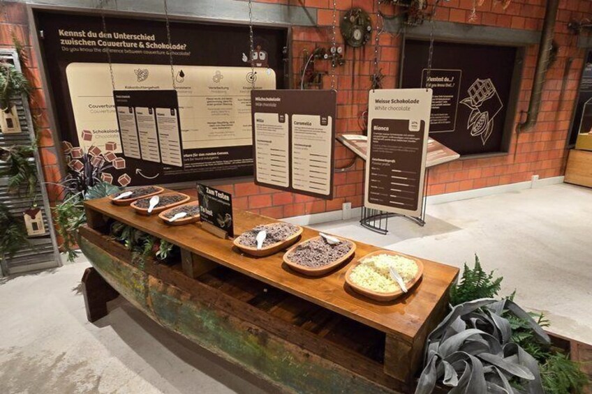 A display of various chocolate products with informational signs. 1
