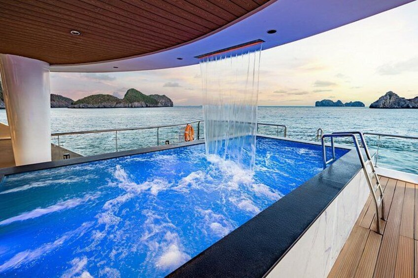 An indoor swimming pool with water jets on a cruise ship deck. 5