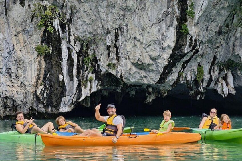 People kayaking in a cave with rocky walls. 4