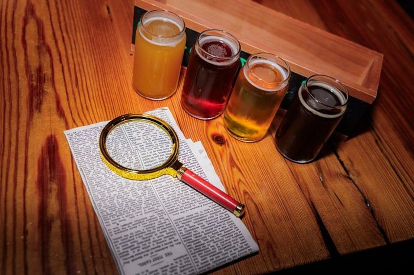 A wooden table with a magnifying glass, a newspaper, and four glasses of beer. 1