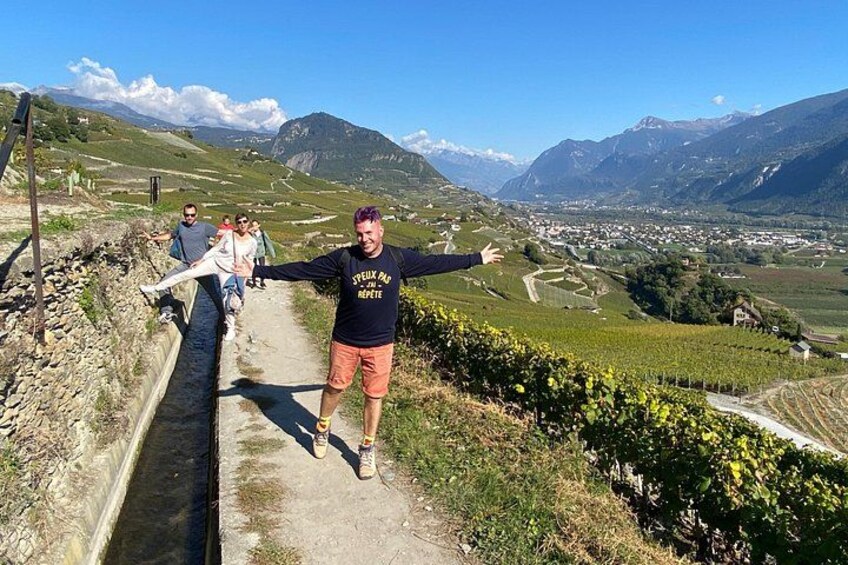 A person walking on a path with a mountainous landscape in the background. 2