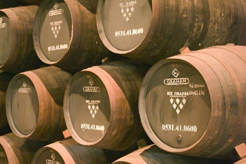 Stacks of wooden barrels with labels and numbers. 2