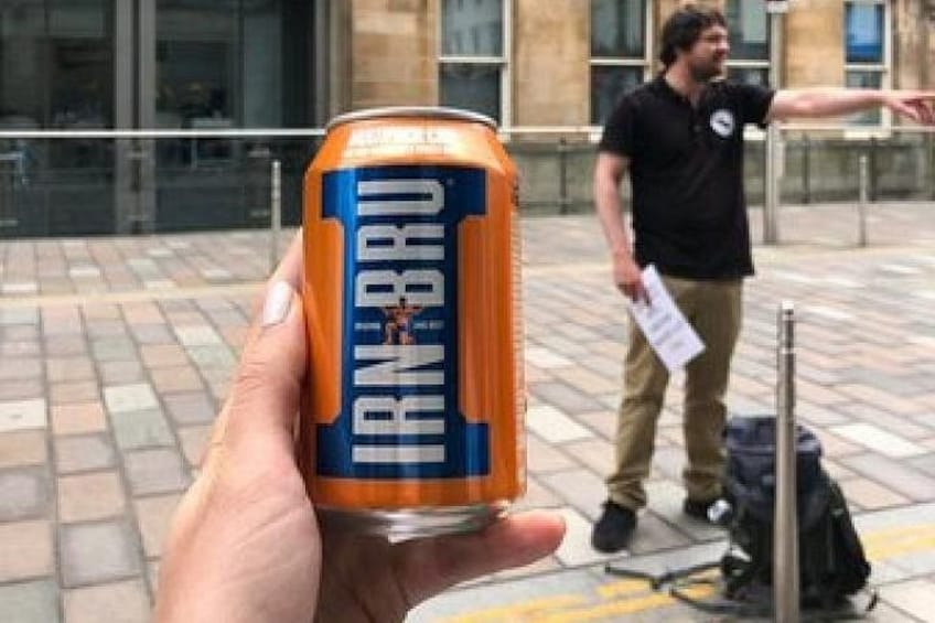 A hand holding a can of IRN BRU beer. 2
