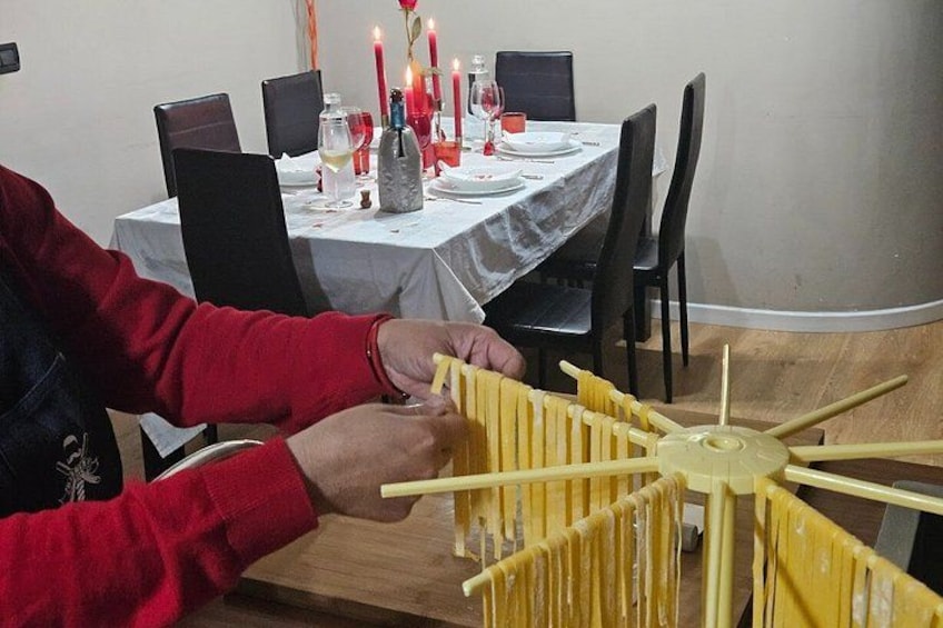 A person assembling a yellow structure with multiple rods. 5