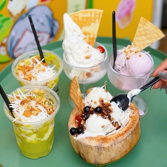 A variety of desserts including ice cream, a banana split, and a green dessert with nuts. 4