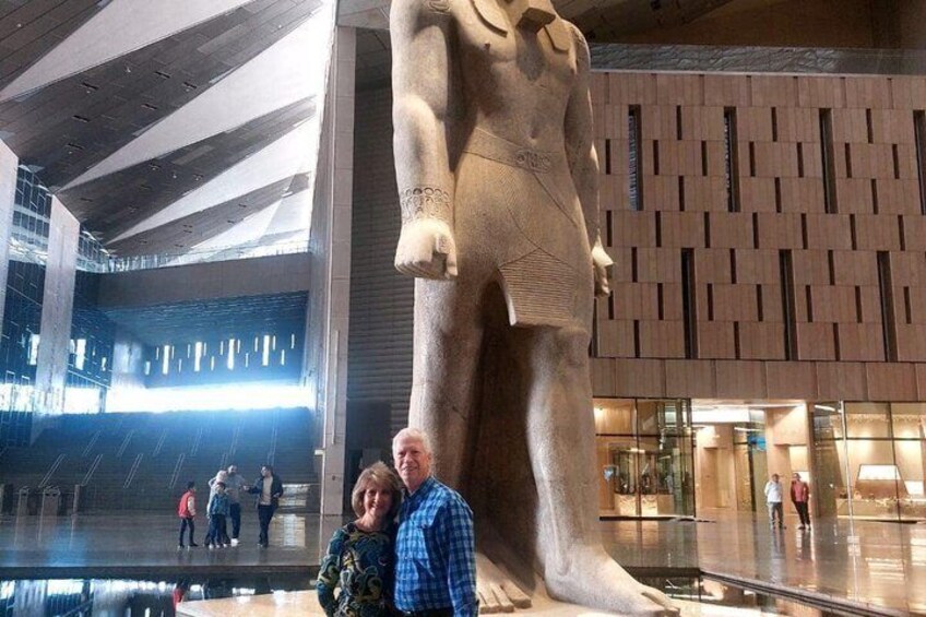 Eine große Statue in einem modernen Gebäude mit einem gemusterten Wand und Glasfenstern. 2