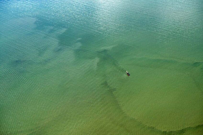A person swimming in a large body of water. 4