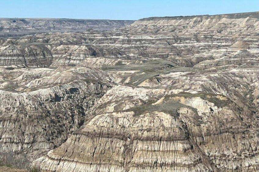 A vast landscape of layered rock formations with distinct strata. 4
