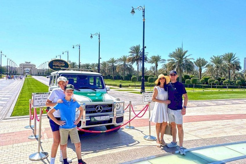 A Mercedes-Benz S-Class SUV parked on a paved area with a red rope barrier, palm trees, and a clear sky in the background. 2